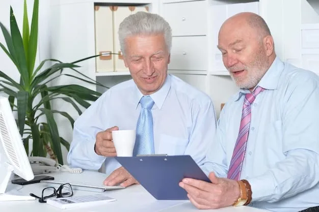A financial advisor with a tablet explaining documents to a senior client at a desk, with graphs and charts on the screen, indicating financial planning.