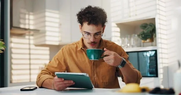 A person happily reviewing financial charts on a tablet, with a calculator and coffee cup nearby, suggesting financial relief and clear planning.
