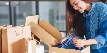 A beautiful young asian woman receiving and opening a postal par