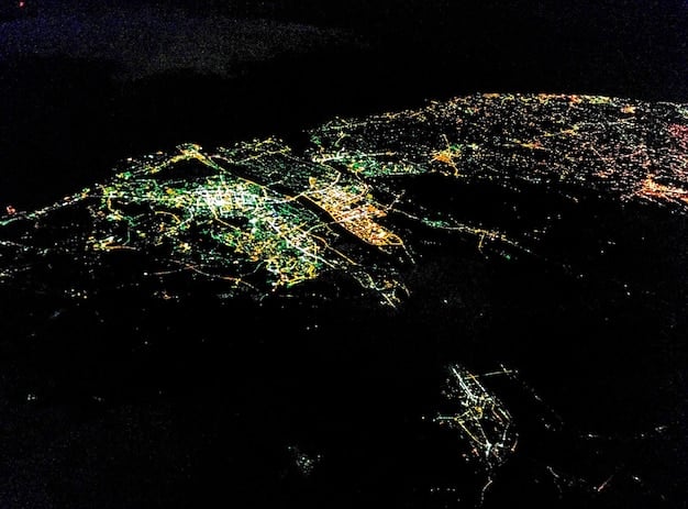 A detailed world map with glowing flight paths, overlayed with snippets of code and data points, symbolizing the global nature of flight data and system intricacies that lead to glitches.