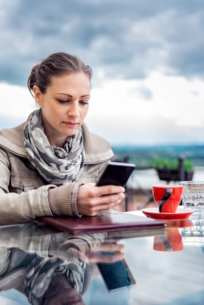 A person using a smartphone to research travel options, symbolizing the importance of online research and staying informed for travel hacks.