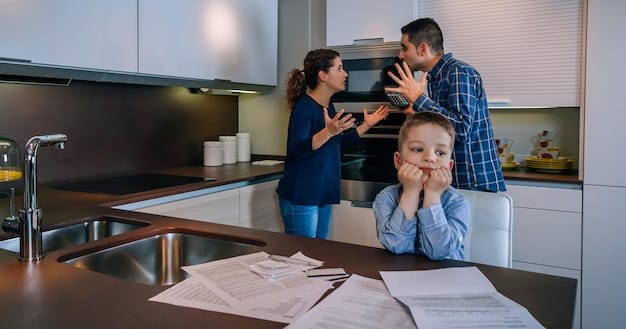 A family sits around a kitchen table, looking thoughtfully at documents related to health insurance, a laptop showing a financial spreadsheet, and a pen, emphasizing the careful consideration of healthcare plans.