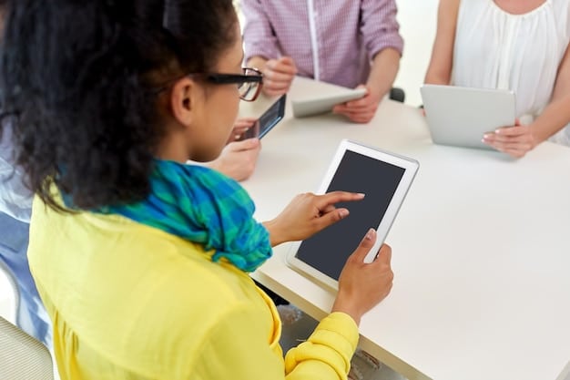 A student using a tablet with assistive technology on screen, likely a text-to-speech application, with a diverse classroom in the blurred background, highlighting inclusive tech use.