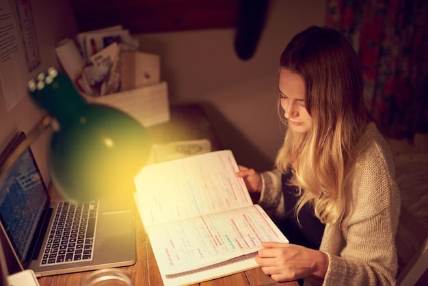 A close-up shot of a student's hand filling out a FAFSA form on a laptop, with financial documents scattered around. The lighting is warm and focused.