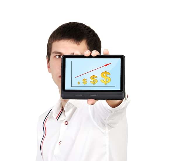 A person looking confidently at an upward trending stock market graph on a tablet, symbolizing smart investment decisions and portfolio growth.