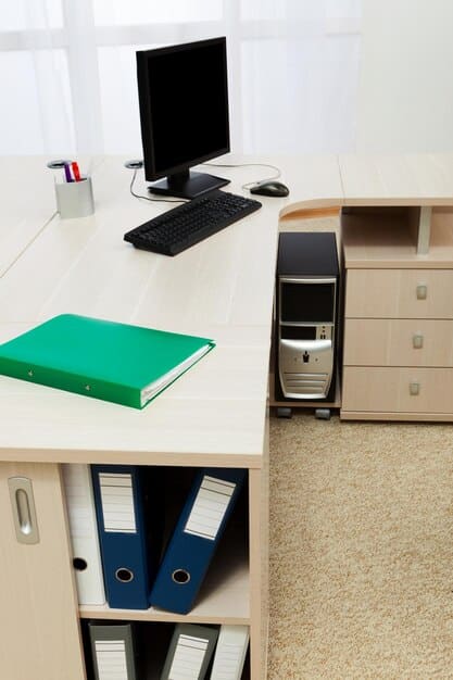 A tidy home office setup with a computer, filing cabinet, and a framed business certificate, symbolizing a dedicated workspace for tax purposes.