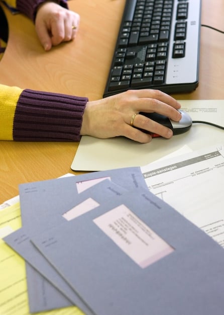 A detailed shot of a person filling out tax forms on a computer, with a focused expression, surrounded by a few essential office items like a pen and a coffee mug, showing the process of tax preparation.