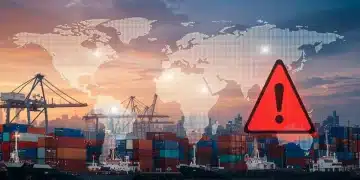 Global supply chain under stress, with warning signs indicating impending disruptions.